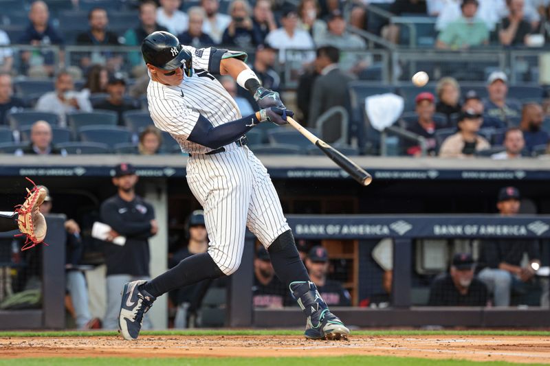 Aug 20, 2024; Bronx, New York, USA; New York Yankees center fielder Aaron Judge (99) hits a solo home run during the first inning against the Cleveland Guardians at Yankee Stadium. Mandatory Credit: Vincent Carchietta-USA TODAY Sports