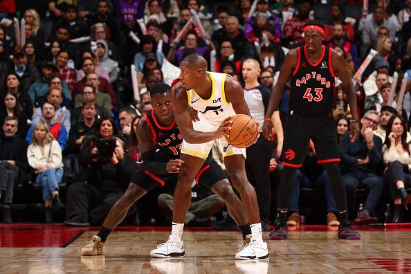 TORONTO, CANADA - DECEMBER 23:  Kris Dunn #11 of the Utah Jazz handles the ball during the game as Dennis Schroder #17 of the Toronto Raptors plays defense on December 23, 2023 at the Scotiabank Arena in Toronto, Ontario, Canada.  NOTE TO USER: User expressly acknowledges and agrees that, by downloading and or using this Photograph, user is consenting to the terms and conditions of the Getty Images License Agreement.  Mandatory Copyright Notice: Copyright 2023 NBAE (Photo by Vaughn Ridley/NBAE via Getty Images)