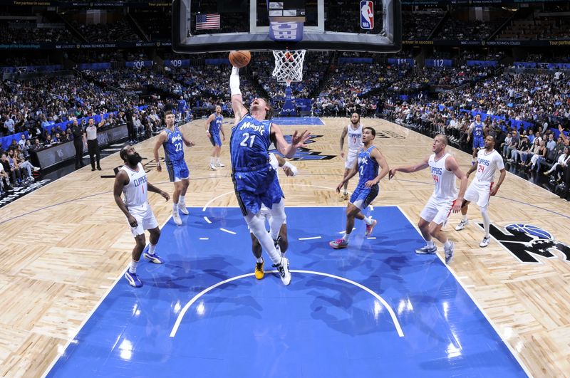 ORLANDO, FL - MARCH 29: Moritz Wagner #21 of the Orlando Magic grabs a rebound during the game against the LA Clippers on March 29, 2024 at the Kia Center in Orlando, Florida. NOTE TO USER: User expressly acknowledges and agrees that, by downloading and or using this photograph, User is consenting to the terms and conditions of the Getty Images License Agreement. Mandatory Copyright Notice: Copyright 2024 NBAE (Photo by Fernando Medina/NBAE via Getty Images)