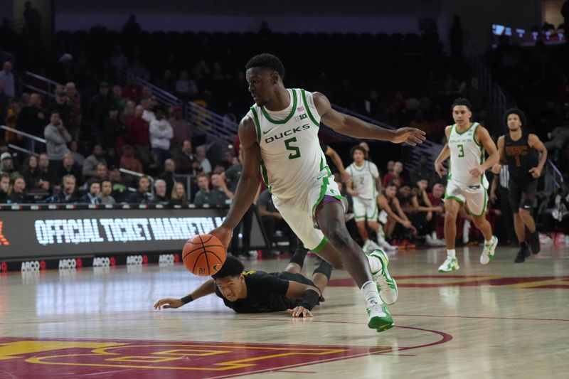 Dec 4, 2024; Los Angeles, California, USA; Oregon Ducks guard TJ Bamba (5) dribbles the ball against Southern California Trojans forward Terrance Williams II (5) in the second half at Galen Center. Mandatory Credit: Kirby Lee-Imagn ImagesDec 4, 2024; Los Angeles, California, USA; at Galen Center. Mandatory Credit: Kirby Lee-Imagn Images