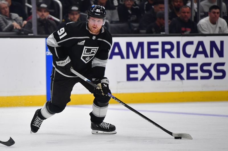 Dec 3, 2023; Los Angeles, California, USA; Los Angeles Kings right wing Carl Grundstrom (91) moves the puck against the Colorado Avalanche during the second period at Crypto.com Arena. Mandatory Credit: Gary A. Vasquez-USA TODAY Sports