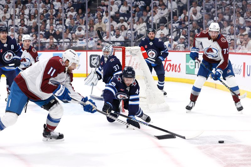 Apr 30, 2024; Winnipeg, Manitoba, CAN;Colorado Avalanche center Andrew Cogliano (11) and Winnipeg Jets defenseman Josh Morrissey (44) chase down the puck in the first period in game five of the first round of the 2024 Stanley Cup Playoffs at Canada Life Centre. Mandatory Credit: James Carey Lauder-USA TODAY Sports