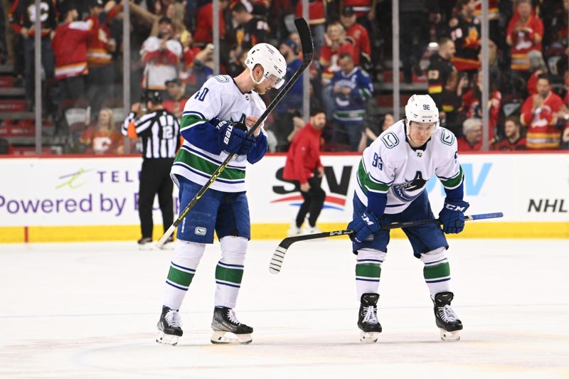 Dec 31, 2022; Calgary, Alberta, CAN; Vancouver Canucks forward Elias Pettersson (40) and forward Andrei Kuzmenko (96) react to a loss to the Calgary Flames at Scotiabank Saddledome. Mandatory Credit: Candice Ward-USA TODAY Sports