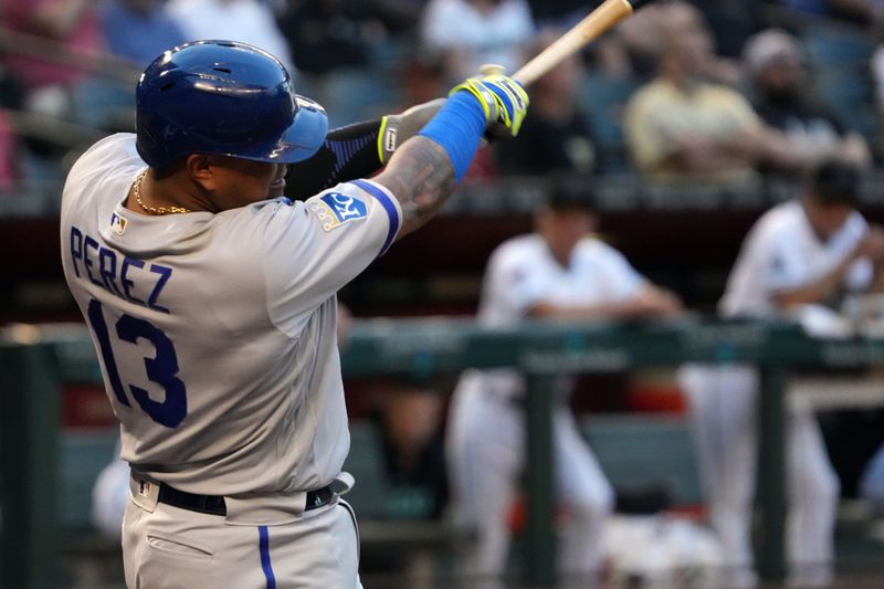 Apr 25, 2023; Phoenix, Arizona, USA; Kansas City Royals catcher Salvador Perez (13) hits a single against the Arizona Diamondbacks during the first inning at Chase Field. Mandatory Credit: Joe Camporeale-USA TODAY Sports