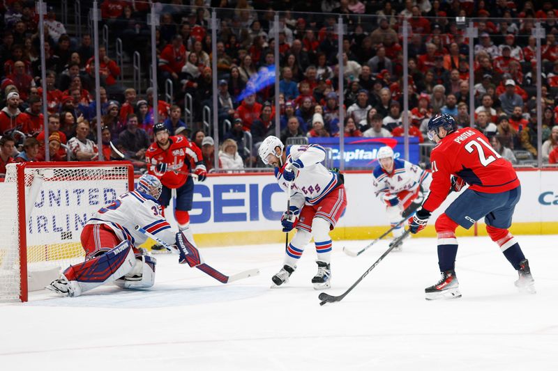 Jan 4, 2025; Washington, District of Columbia, USA; New York Rangers goaltender Jonathan Quick (32) makes a save on Washington Capitals center Aliaksei Protas (21) in the first period at Capital One Arena. Mandatory Credit: Geoff Burke-Imagn Images