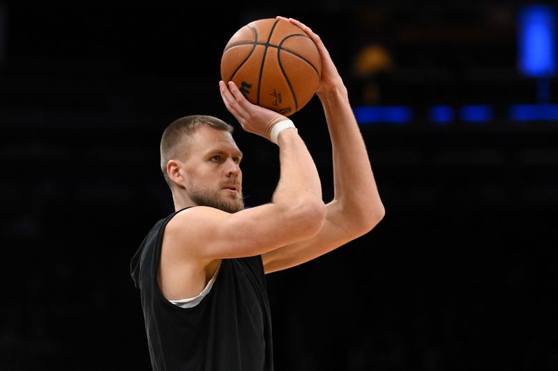 BOSTON, MASSACHUSETTS - JANUARY 13: Kristaps Porzingis #8 of the Boston Celtics takes a shot during warmups before a game against the Houston Rockets at the TD Garden on January 13, 2024 in Boston, Massachusetts. NOTE TO USER: User expressly acknowledges and agrees that, by downloading and or using this photograph, User is consenting to the terms and conditions of the Getty Images License Agreement. (Photo by Brian Fluharty/Getty Images)