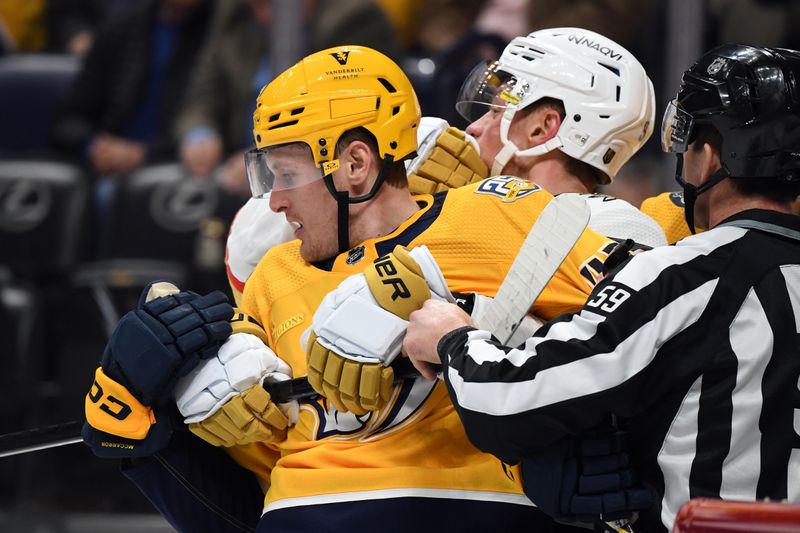 Mar 26, 2024; Nashville, Tennessee, USA; Nashville Predators right wing Michael McCarron (47) is held by Vegas Golden Knights center Jack Eichel (9) after a play during the first period at Bridgestone Arena. Mandatory Credit: Christopher Hanewinckel-USA TODAY Sports