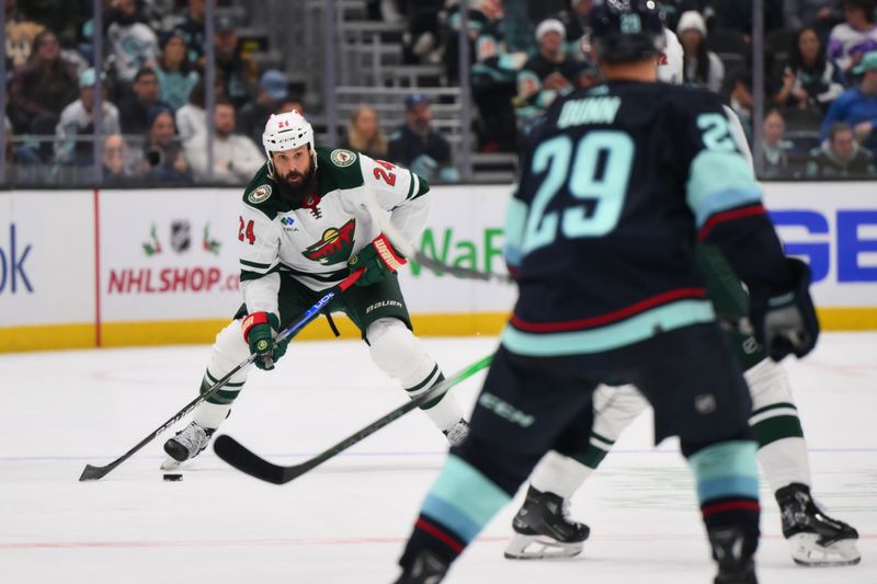 Dec 10, 2023; Seattle, Washington, USA; Minnesota Wild defenseman Zach Bogosian (24) advances the puck against the Seattle Kraken during the third period at Climate Pledge Arena. Mandatory Credit: Steven Bisig-USA TODAY Sports