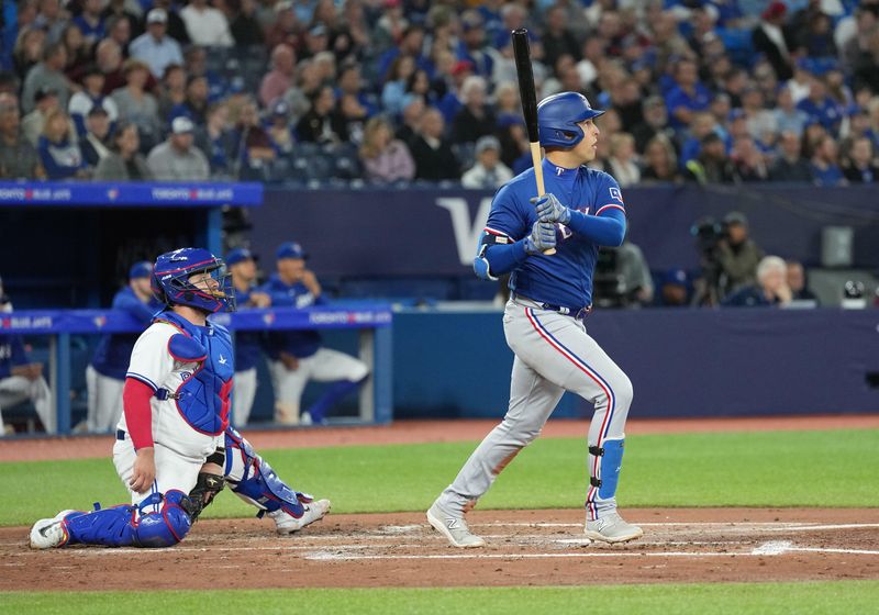 Sep 13, 2023; Toronto, Ontario, CAN; Texas Rangers first baseman Nathaniel Lowe (30) hits a tree run home run against the Toronto Blue Jays during the fourth inning at Rogers Centre. Mandatory Credit: Nick Turchiaro-USA TODAY Sports