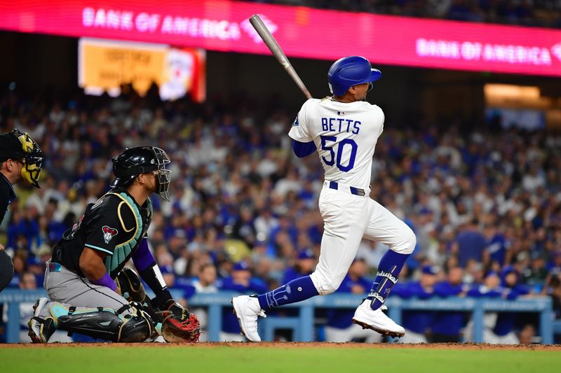 May 19, 2025; Los Angeles, California, USA; Los Angeles Dodgers shortstop Mookie Betts (50) hits a solo home run against the Arizona Diamondbacks during the sixth inning at Dodger Stadium. Mandatory Credit: Gary A. Vasquez-Imagn Images