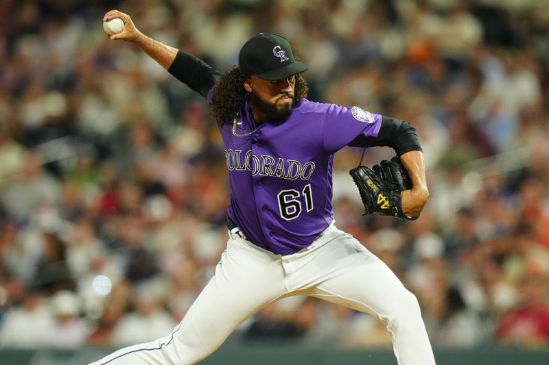 Jul 18, 2023; Denver, Colorado, USA;  Colorado Rockies relief pitcher Justin Lawrence (61) delivers a pitch in the ninth inning against the Houston Astros at Coors Field. Mandatory Credit: Ron Chenoy-USA TODAY Sports