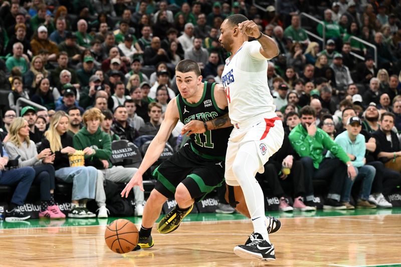 BOSTON, MASSACHUSETTS - JANUARY 27: Payton Pritchard #11 of the Boston Celtics drives to the basket against Norman Powell #24 of the LA Clippers during the second quarter at the TD Garden on January 27, 2024 in Boston, Massachusetts. NOTE TO USER: User expressly acknowledges and agrees that, by downloading and or using this photograph, User is consenting to the terms and conditions of the Getty Images License Agreement. (Photo by Brian Fluharty/Getty Images)