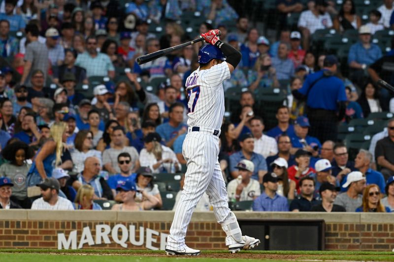 Jul 17, 2023; Chicago, Illinois, USA;  Chicago Cubs right fielder Seiya Suzuki (27) raises his bat after striking out swinging during the third inning against the Washington Nationals at Wrigley Field. Mandatory Credit: Matt Marton-USA TODAY Sports