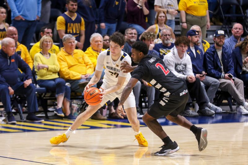 Jan 6, 2026; Morgantown, West Virginia, USA; West Virginia Mountaineers guard Treysen Eaglestaff (52) and Cincinnati Bearcats guard Jizzle James (2) fight for a loose ball during the second half at Hope Coliseum. Mandatory Credit: Ben Queen-Imagn Images