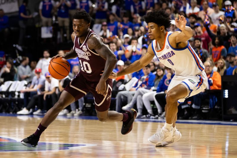 Jan 24, 2024; Gainesville, Florida, USA; Mississippi State Bulldogs guard Dashawn Davis (10) dribbles the ball away from Florida Gators guard Zyon Pullin (0) during the first half at Exactech Arena at the Stephen C. O'Connell Center. Mandatory Credit: Matt Pendleton-USA TODAY Sports