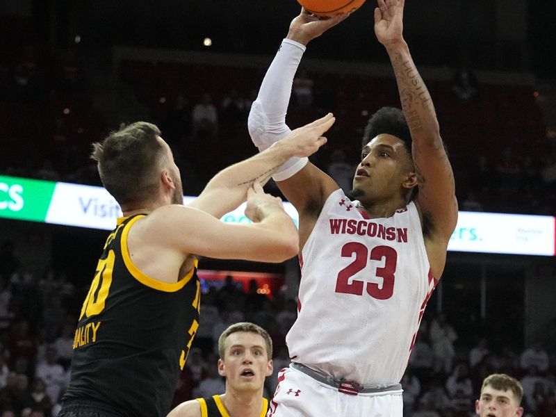 Feb 22, 2023; Madison, Wisconsin, USA; Wisconsin guard Chucky Hepburn (23) shoots the ball against Iowa guard Connor McCaffery (30) during the second half at Kohl Center. Mandatory Credit: Mark Hoffman-USA TODAY Sports