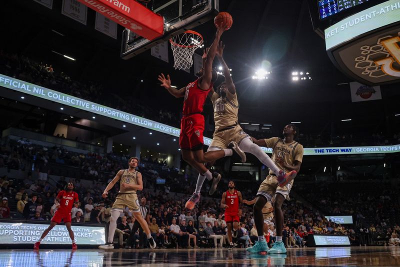 Mar 1, 2025; Atlanta, Georgia, USA; North Carolina State Wolfpack guard Marcus Hill (10) shoots past Georgia Tech Yellow Jackets forward Ibrahim Souare (30) in the first half at McCamish Pavilion. Mandatory Credit: Brett Davis-Imagn Images
