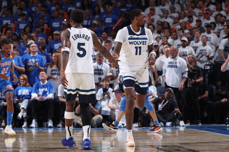 OKLAHOMA CITY, OK - MAY 28: Anthony Edwards #5 high fives Naz Reid #11 of the Minnesota Timberwolves during the game against the Oklahoma City Thunder during Game 5 of the 2025 NBA Western Conference Finals  on May 28, 2025 at Paycom Center in Oklahoma City, Oklahoma. NOTE TO USER: User expressly acknowledges and agrees that, by downloading and or using this photograph, User is consenting to the terms and conditions of the Getty Images License Agreement. Mandatory Copyright Notice: Copyright 2025 NBAE (Photo by Joe Murphy/NBAE via Getty Images)