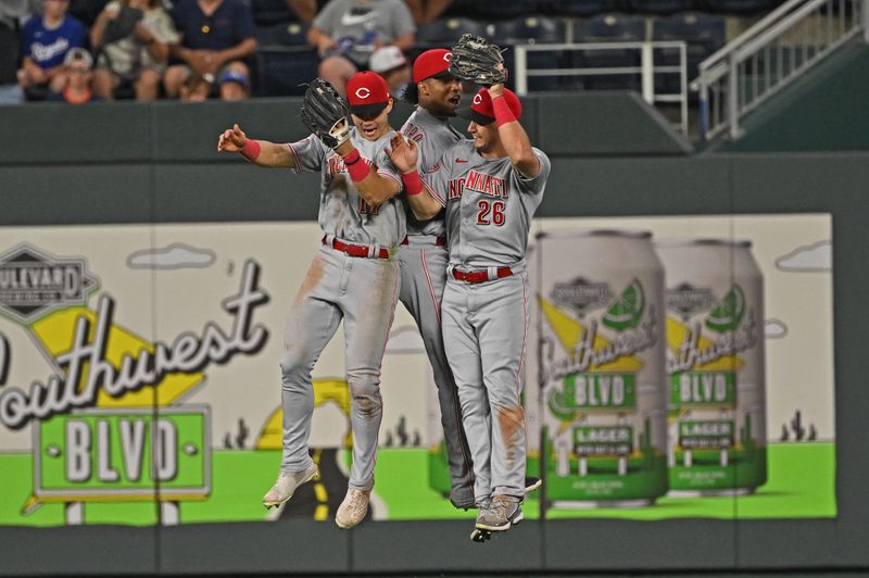 Jun 14, 2023; Kansas City, Missouri, USA;  Cincinnati Reds left fielder Stuart Fairchild (left), center fielder Jose Barrero (center) and right fielder T.J. Hopkins (right) celebrate after beating the Kansas City Royals at Kauffman Stadium. Mandatory Credit: Peter Aiken-USA TODAY Sports