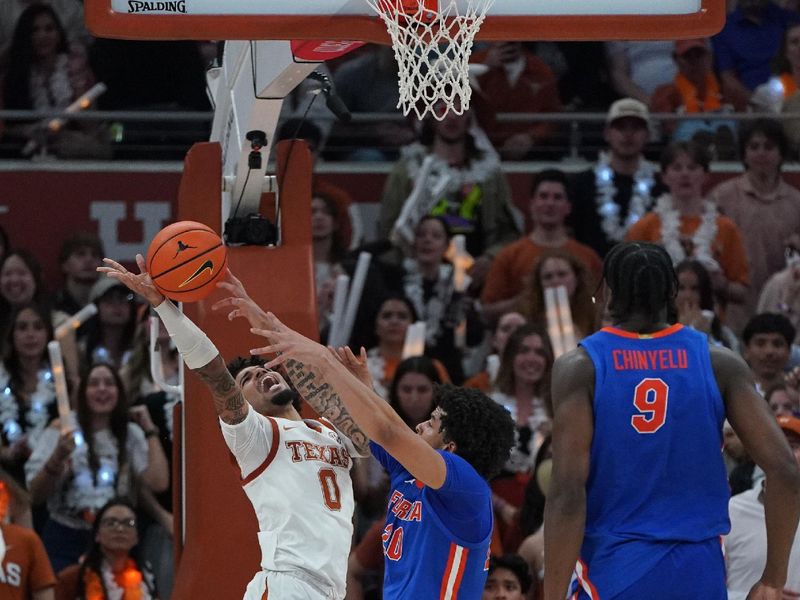 Feb 25, 2026; Austin, Texas, USA; Texas Longhorns guard Jordan Pope (0) shoots a lay up against Florida Gators guard Isaiah Brown (20) during the second half at Moody Center. Mandatory Credit: Dustin Safranek-Imagn Images