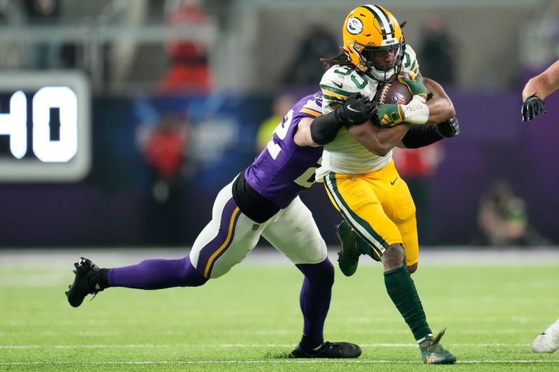 Minnesota Vikings' Harrison Smith stops Green Bay Packers' Aaron Jones during the second half of an NFL football game Sunday, Dec. 31, 2023, in Minneapolis. (AP Photo/Abbie Parr)