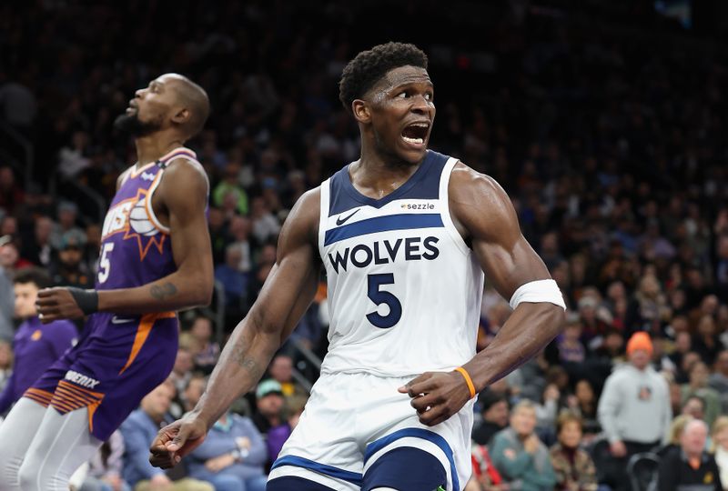 PHOENIX, ARIZONA - JANUARY 29: Anthony Edwards #5 of the Minnesota Timberwolves reacts to a slam dunk against Kevin Durant #35 of the Phoenix Suns during the second half of the NBA game at Footprint Center on January 29, 2025 in Phoenix, Arizona. The Timberwolves defeated the Suns 121-113. NOTE TO USER: User expressly acknowledges and agrees that, by downloading and or using this photograph, User is consenting to the terms and conditions of the Getty Images License Agreement.  (Photo by Christian Petersen/Getty Images)