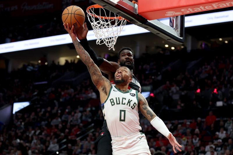 PORTLAND, OREGON - JANUARY 31: Deandre Ayton #2 of the Portland Trail Blazers blocks the shot of Damian Lillard #0 of the Milwaukee Bucks during the second quarter at Moda Center on January 31, 2024 in Portland, Oregon. (Photo by Steph Chambers/Getty Images)