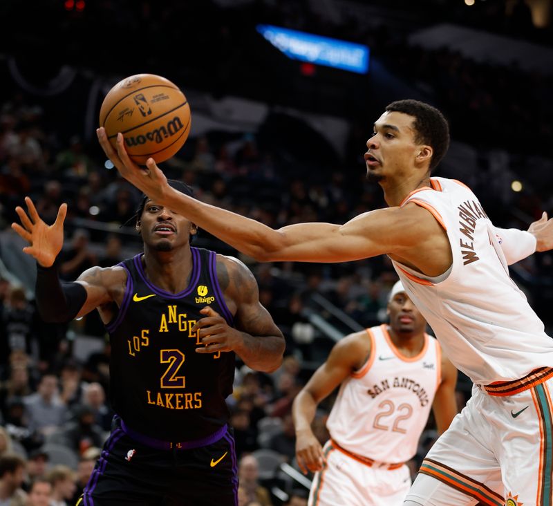 SAN ANTONIO, TX - DECEMBER 15:  Victor Wembanyama #1 of the San Antonio Spurs saves the ball from going out of bounds against the Los Angeles Lakers in the first half at Frost Bank Center on December  15, 2023 in San Antonio, Texas. NOTE TO USER: User expressly acknowledges and agrees that, by downloading and or using this photograph, User is consenting to terms and conditions of the Getty Images License Agreement. (Photo by Ronald Cortes/Getty Images)