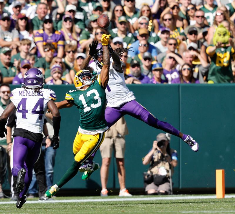 Minnesota Vikings cornerback Shaquill Griffin (1) defends a pass intended for Green Bay Packers wide receiver Dontayvion Wicks (13) during a NFL football game Sunday, Sept. 29, 2024, in Green Bay, Wis. (AP Photo/Jeffrey Phelps