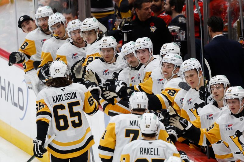 Nov 8, 2024; Washington, District of Columbia, USA; Pittsburgh Penguins defenseman Erik Karlsson (65) celebrates with teammates after scoring a goal against the Washington Capitals in the first period at Capital One Arena. Mandatory Credit: Geoff Burke-Imagn Images