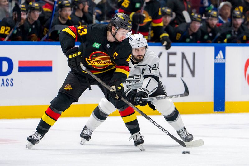 Mar 25, 2024; Vancouver, British Columbia, CAN;  Los Angeles Kings forward Phillip Danault (24) stick checks Vancouver Canucks defenseman Quinn Hughes (43) in the second period at Rogers Arena. Mandatory Credit: Bob Frid-USA TODAY Sports