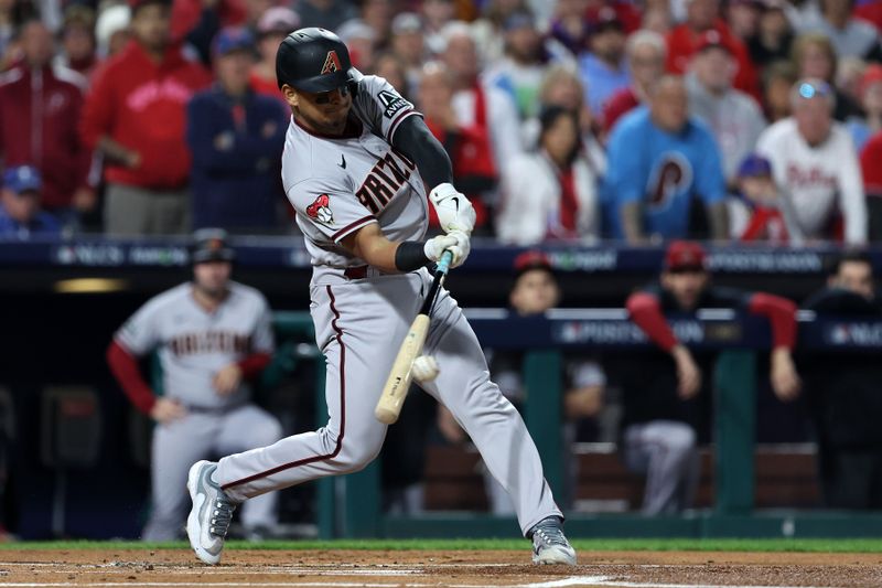 Oct 24, 2023; Philadelphia, Pennsylvania, USA; Arizona Diamondbacks catcher Gabriel Moreno (14) hits a single against the Philadelphia Phillies in the first inning for game seven of the NLCS for the 2023 MLB playoffs at Citizens Bank Park. Mandatory Credit: Bill Streicher-USA TODAY Sports