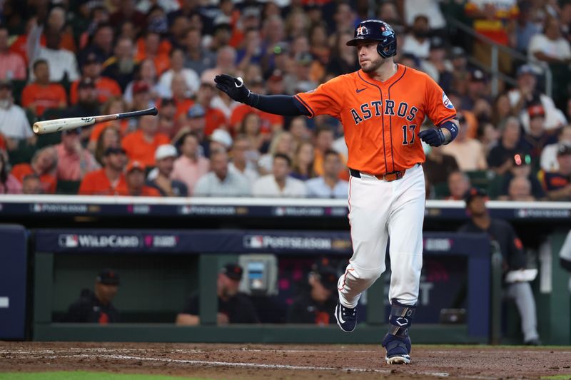 Oct 2, 2024; Houston, Texas, USA; Houston Astros catcher Victor Caratini (17) tosses his bat and runs to first base after being hit by a pitch against the Detroit Tigers during the fourth inning of game two of the Wildcard round for the 2024 MLB Playoffs at Minute Maid Park. Mandatory Credit: Thomas Shea-Imagn Images