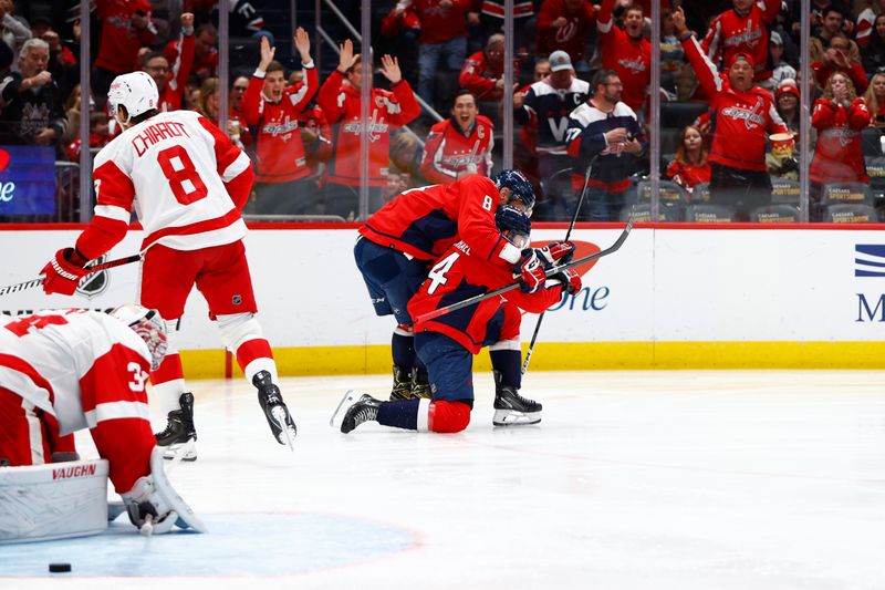 Mar 26, 2024; Washington, District of Columbia, USA; Washington Capitals center Connor McMichael (24) celebrates with Capitals left wing Alex Ovechkin (8) after scoring a goal against Detroit Red Wings goaltender Alex Lyon (34) during the third period at Capital One Arena. Mandatory Credit: Amber Searls-USA TODAY Sports