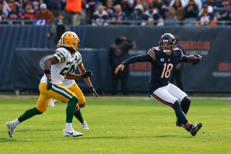 Chicago Bears quarterback Caleb Williams (18) runs with the ball against the Green Bay Packers during the first half of an NFL football game, Sunday, Nov. 17, 2024, in Chicago. (AP Photo/Kamil Krzaczynski)