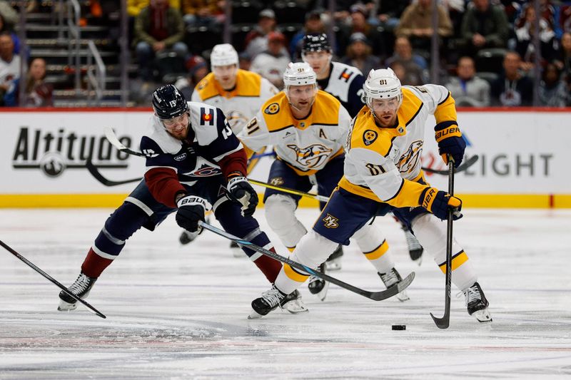 Dec 14, 2024; Denver, Colorado, USA; Nashville Predators center Jonathan Marchessault (81) controls the puck ahead of Colorado Avalanche right wing Valeri Nichushkin (13) in the first period at Ball Arena. Mandatory Credit: Isaiah J. Downing-Imagn Images