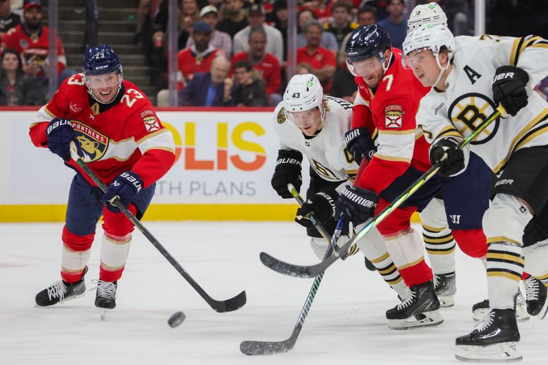 Nov 22, 2023; Sunrise, Florida, USA; Boston Bruins center Danton Heinen (43) battle for the puck against Florida Panthers defenseman Dmitry Kulikov (7) and center Carter Verhaeghe (23) during the second period at Amerant Bank Arena. Mandatory Credit: Sam Navarro-USA TODAY Sports