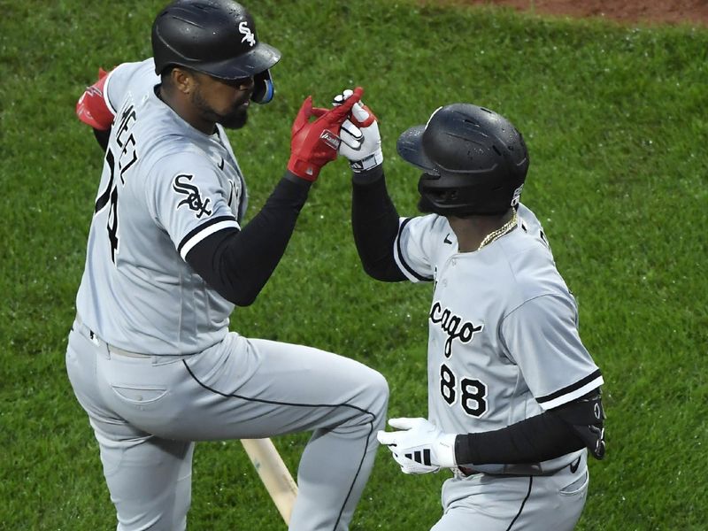 Sep 23, 2023; Boston, Massachusetts, USA;  Chicago White Sox center fielder Luis Robert Jr. (88) reacts with designated hitter Eloy Jimenez (74) after hitting a home run during the ninth inning against the Boston Red Sox at Fenway Park. Mandatory Credit: Bob DeChiara-USA TODAY Sports