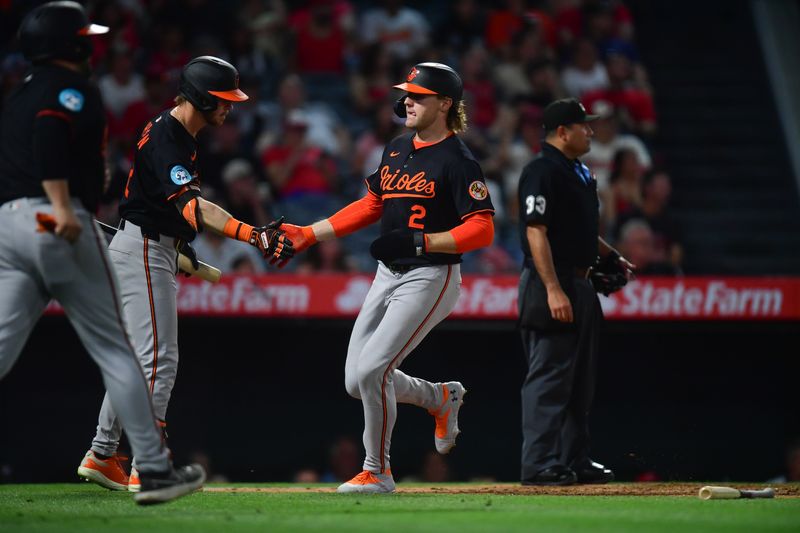 May 10, 2025; Anaheim, California, USA; Baltimore Orioles designated hitter Gunnar Henderson (2) is greeted by right fielder Ryan O'Hearn (32) after scoring a run against the Los Angeles Angels during the sixth inning at Angel Stadium. Mandatory Credit: Gary A. Vasquez-Imagn Images