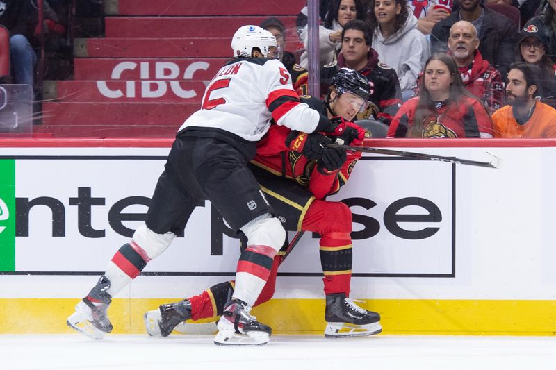 Dec 9, 2025; Ottawa, Ontario, CAN; New Jersey Devils defenseman Brendan Dillon (5) applies a check to Ottawa Senators center Stephen Halliday (83) in the first period at the Canadian Tire Centre. Mandatory Credit: Marc DesRosiers-IMAGN Images