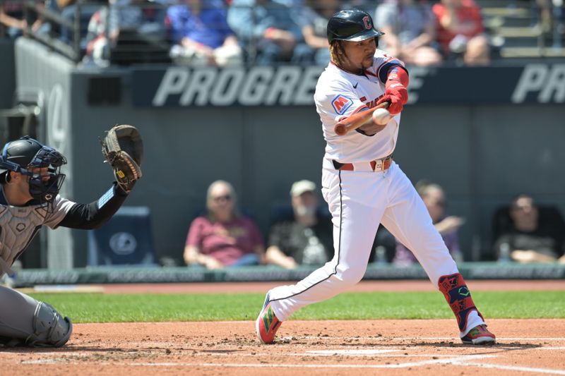 Apr 23, 2025; Cleveland, Ohio, USA; Cleveland Guardians designated hitter Jose Ramirez (11) hits an RBI single during the first inning against the New York Yankees at Progressive Field. Mandatory Credit: Ken Blaze-Imagn Images