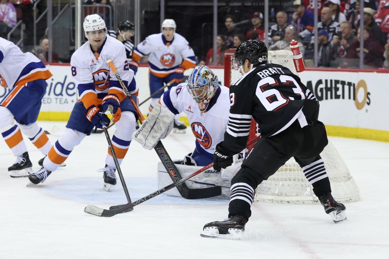 Apr 13, 2025; Newark, New Jersey, USA; New York Islanders goaltender Ilya Sorokin (30) makes a save on New Jersey Devils left wing Jesper Bratt (63) during the second period at Prudential Center. Mandatory Credit: Ed Mulholland-Imagn Images