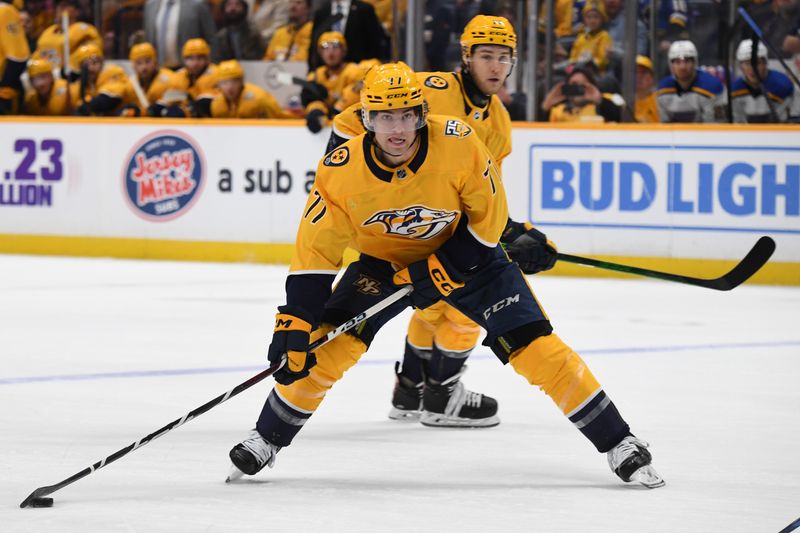 Apr 4, 2024; Nashville, Tennessee, USA; Nashville Predators right wing Luke Evangelista (77) looks to pass the puck during the first period against the St. Louis Blues at Bridgestone Arena. Mandatory Credit: Christopher Hanewinckel-USA TODAY Sports