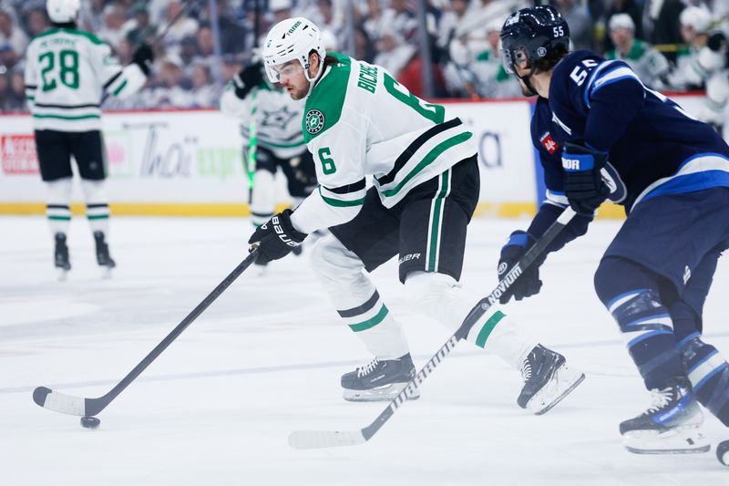 May 7, 2025; Winnipeg, Manitoba, CAN; Dallas Stars defenseman Liam Bichsel (6) tries to skate away from Winnipeg Jets forward Mark Scheifele (55) during the first period in game one of the second round of the 2025 Stanley Cup Playoffs at Canada Life Centre. Mandatory Credit: Terrence Lee-Imagn Images