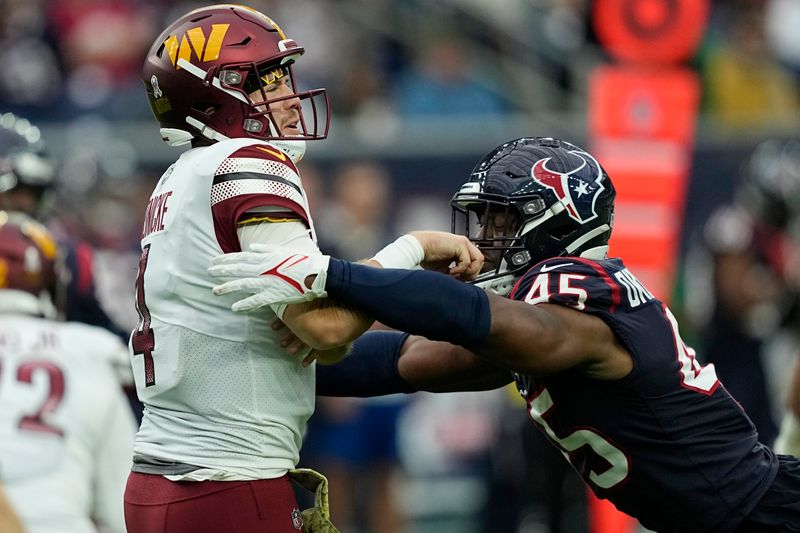 Washington Commanders quarterback Taylor Heinicke (4) is hit by Houston Texans linebacker Ogbonnia Okoronkwo (45) after a throw during the second half of an NFL football game Sunday, Nov. 20, 2022, in Houston. (AP Photo/David J. Phillip)