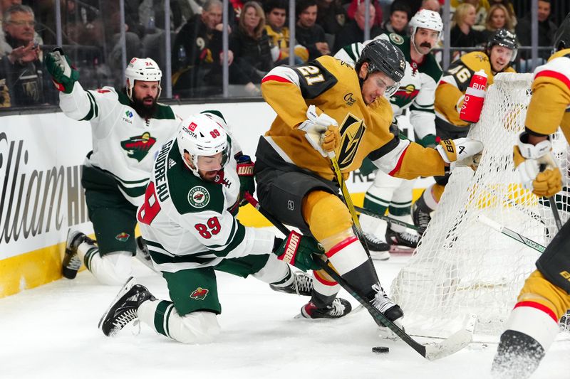 Feb 12, 2024; Las Vegas, Nevada, USA; Vegas Golden Knights center Brett Howden (21) and Minnesota Wild center Frederick Gaudreau (89) vie for the puck during the third period at T-Mobile Arena. Mandatory Credit: Stephen R. Sylvanie-USA TODAY Sports