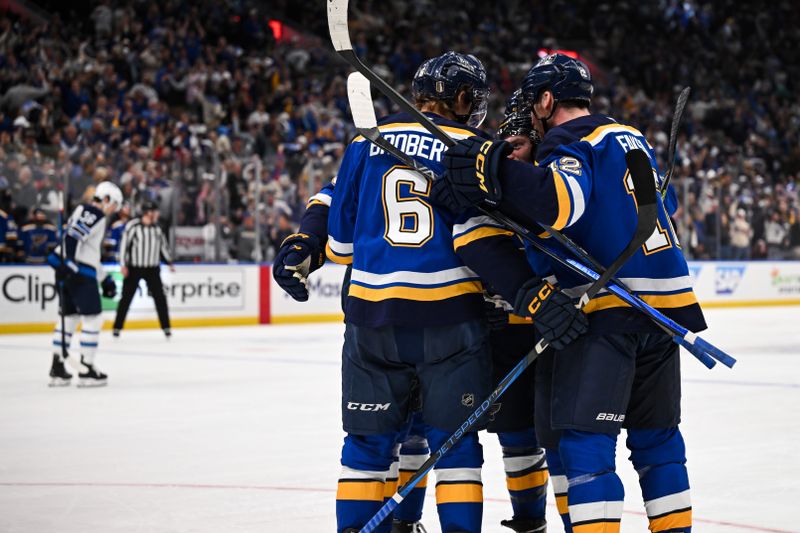 May 2, 2025; St. Louis, Missouri, USA; St. Louis Blues left wing Nathan Walker (26) celebrates with teammates after scoring a goal against the Winnipeg Jets during the second period in game six of the first round of the 2025 Stanley Cup Playoffs at Enterprise Center. Mandatory Credit: Connor Hamilton-Imagn Images