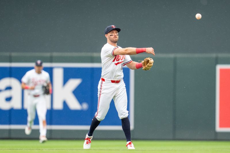 Jun 7, 2025; Minneapolis, Minnesota, USA; Minnesota Twins second base Kody Clemens (18) throws out Toronto Blue Jays third base Addison Barger (47) in the ninth inning at Target Field. Mandatory Credit: Matt Blewett-Imagn Images