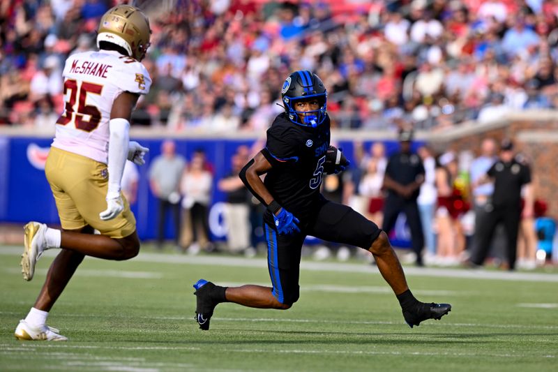 Nov 16, 2024; Dallas, Texas, USA; SMU Mustangs wide receiver Moochie Dixon (5) tries to elude Boston College Eagles defensive back Ashton McShane (35) during the first half at the Gerald J. Ford Stadium. Mandatory Credit: Jerome Miron-Imagn Images