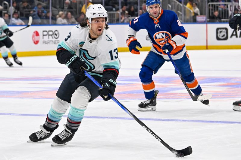 Feb 13, 2024; Elmont, New York, USA; Seattle Kraken left wing Brandon Tanev (13) skates with the puck against the New York Islanders during the first period at UBS Arena. Mandatory Credit: Dennis Schneidler-USA TODAY Sports